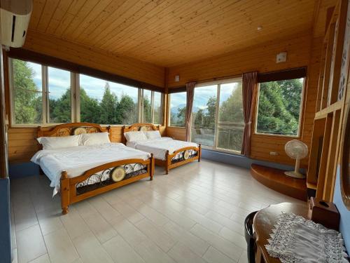 a bedroom with two beds in a room with windows at View on View B&B in Puli