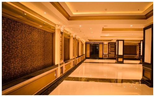 a hallway of a building with a tile floor at THE DOWNTOWN in Kānpur