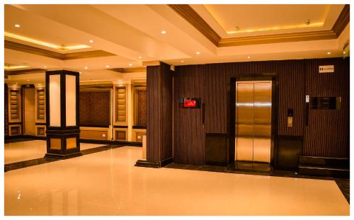 a lobby with two elevators in a building at THE DOWNTOWN in Kānpur