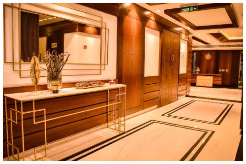 a hallway with a table and a mirror in a building at THE DOWNTOWN in Kānpur