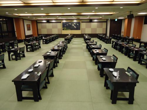 a large dining room with tables and chairs at Yamagisi Ryokan in Fujikawaguchiko