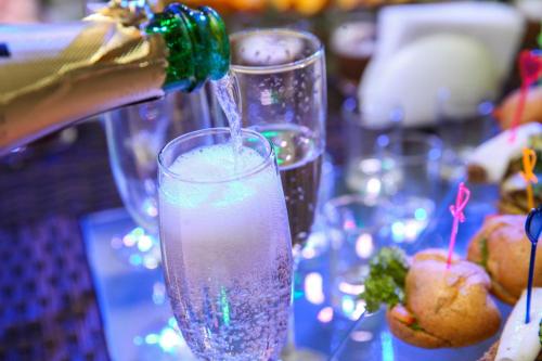 a person is pouring a drink into a glass at Villa Grand in Skhidnitsa