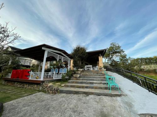 a house with stairs and chairs and a porch at View on View B&B in Puli