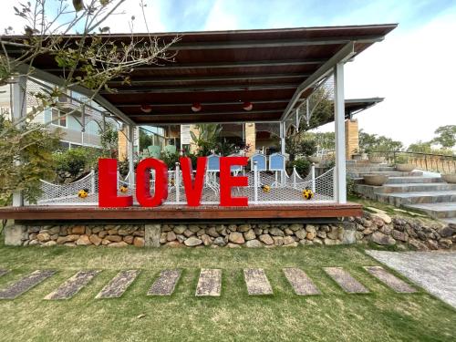 a sign that says love in front of a house at View on View B&B in Puli