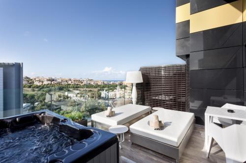 a bathroom with a hot tub on the roof of a building at H Hotel & SPA - Adults Only in St Julian's