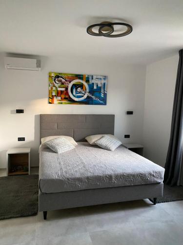 a bedroom with a bed and a ceiling at Apartments & Room Piutti in Bale
