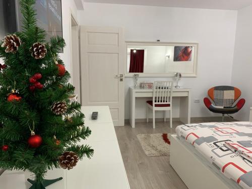 a christmas tree in a room with a bedroom at Luxury Apartment in Galaţi