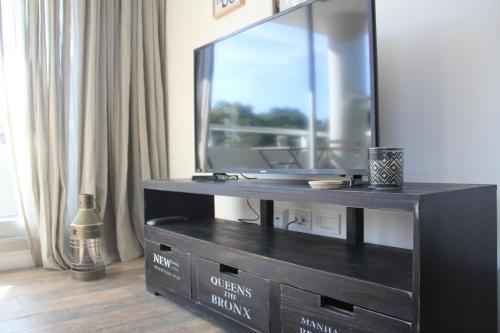 a black entertainment center with a large mirror at Barrancas de Madero in Buenos Aires