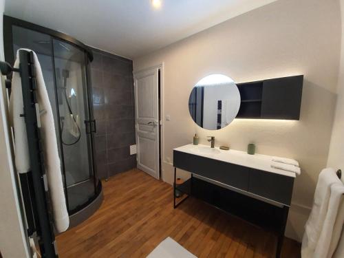 a bathroom with a sink and a shower and a mirror at chambre romantique dans le château de la Bouchatte in Chazemais