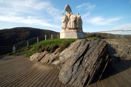 a statue sitting on top of a rock at Gite Vallée et Semoy in Tournavaux