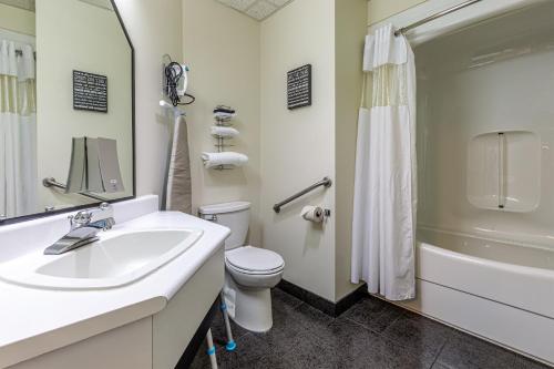 a bathroom with a sink and a toilet and a shower at Days Inn by Wyndham Berthierville in Berthierville