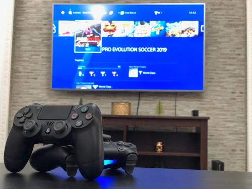 a video game controller sitting on a table in front of a tv at Chez Marcel Sinaia in Sinaia