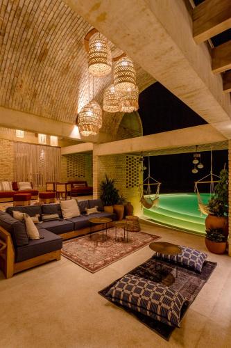 a large living room with couches and tables at Casona Sforza in Puerto Escondido