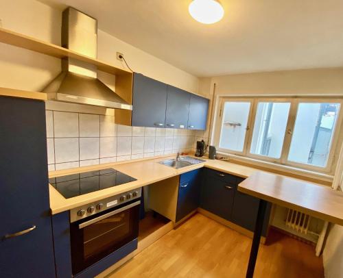 a kitchen with a sink and a stove top oven at Gemütliches WG-Zimmer 4, zentral in Ravensburg (stadtnah), Balkon in Ravensburg