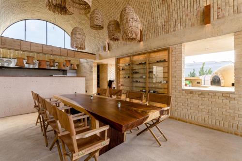 a dining room with a large wooden table and chairs at Casona Sforza in Puerto Escondido