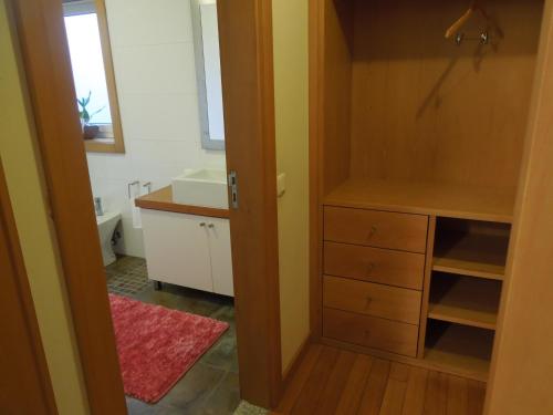 a small bathroom with a sink and a cabinet at Casa das Bocelinhas in Arouca