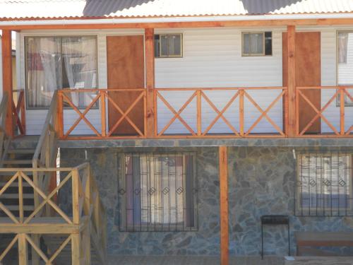 a house being constructed with wooden doors and windows at Cabañas Las Palmeras Pichilemu in Pichilemu