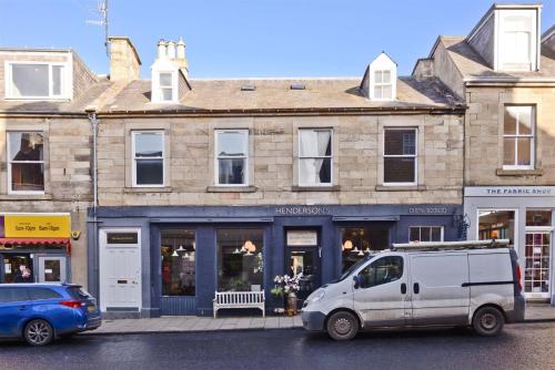 a white van parked in front of a building at The Tweed in the centre of Melrose in Melrose