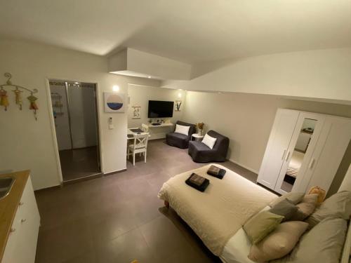 a bedroom with a bed and a living room at Galilee Gali in Kefar Weradim