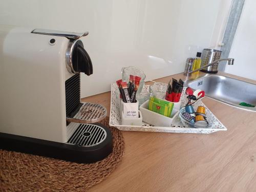 a coffee maker sitting on a counter next to a sink at Galilee Gali in Kefar Weradim