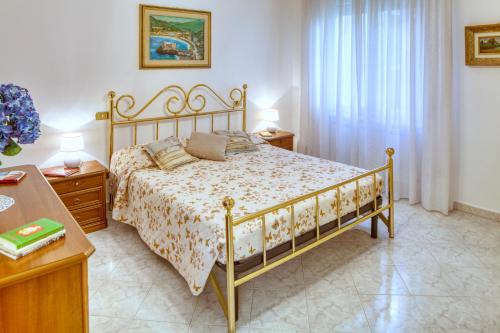 ein Schlafzimmer mit einem Bett, zwei Tischen und einem Fenster in der Unterkunft ELENA House in Levanto