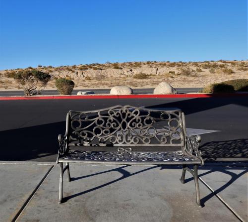 a metal bench sitting on top of a boat at Oasis Inn & Suites 29 Palms Hotel Joshua Tree National Park in Twentynine Palms