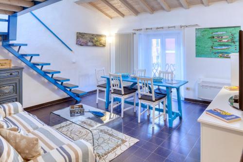 a living room with a blue table and chairs at IVANA Apartment in Levanto