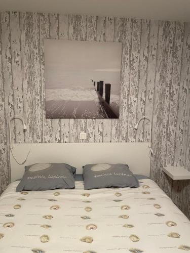 a bedroom with a bed with a picture on the wall at Sea 2 in Middelkerke