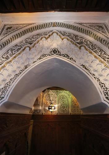 an archway in a building with a painting on it at Riad Hiba in Meknès