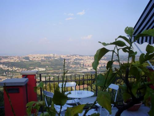 a table and chairs on a balcony with a view at B&B Spring in Perugia
