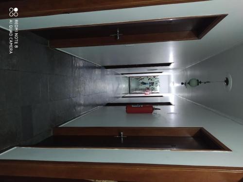 a kitchen with a sink in a room at Hotel Haloha in Peruíbe