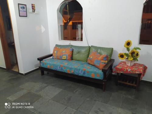 a living room with a couch and a mirror at Hotel Haloha in Peruíbe