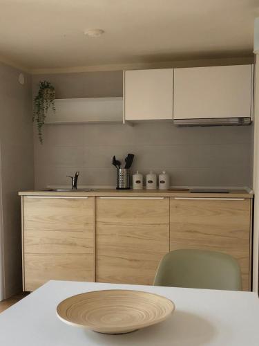 a kitchen with a table and a white counter at Dimora Sole Raggiante in Venosa