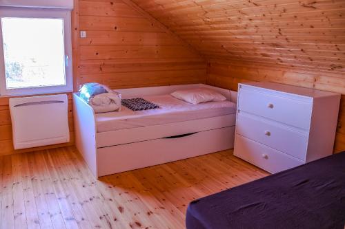 a small room with a bed and a window at Insolite maison bois, wifi, streaming au coeur de l'Argonne et des batailles de Verdun in Chaudefontaine