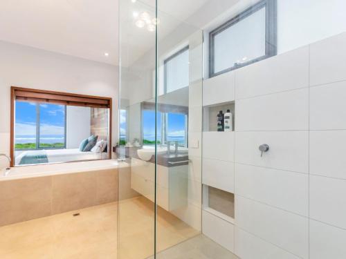 a bathroom with a glass shower and a bath tub at Stone and Sea in Port Fairy