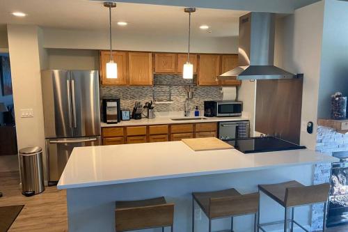 a kitchen with a white counter and a refrigerator at Very Spacious apartment close to Lions Head Gondola in Vail