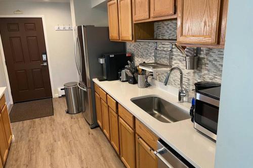 a kitchen with a sink and a refrigerator at Very Spacious apartment close to Lions Head Gondola in Vail