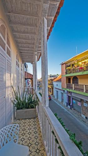 a balcony with a table and chairs on a street at Lunalá Hotel Boutique in Cartagena de Indias