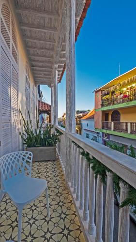 a white chair sitting on a balcony of a building at Lunalá Hotel Boutique in Cartagena de Indias