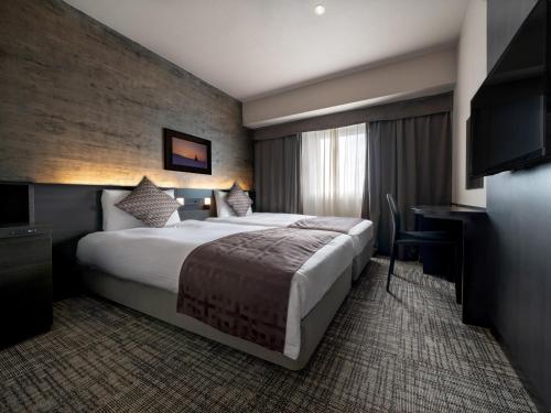Ένα ή περισσότερα κρεβάτια σε δωμάτιο στο Premier Hotel -CABIN- Asahikawa
