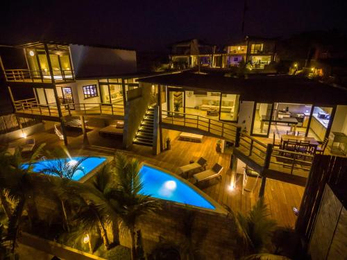an aerial view of a house with two pools at night at Casas Lua & Mar - Vichayito - Máncora in Vichayito