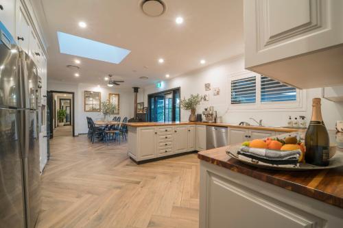 a kitchen with a table with a plate of fruit on a counter at Argentille Boutique Accommodation in Rothbury