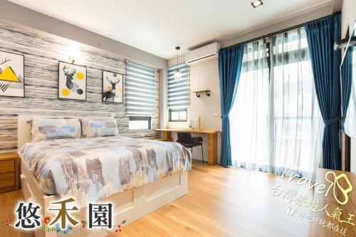 a bedroom with a bed and a wooden wall at Host Garden悠禾園 in Hualien City