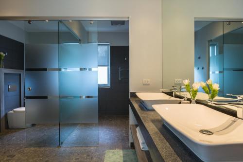 a bathroom with three sinks and a row of mirrors at Villa Sasipimon - Panoramic Duplex Studio in Chaweng Noi Beach