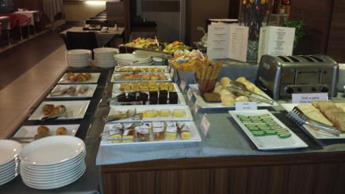 a buffet with many different types of pastries on display at Best Western Plus Hotel Monza e Brianza Palace in Cinisello Balsamo