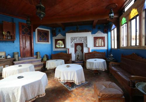 a living room with two tables and a couch at Riad Hiba in Meknès
