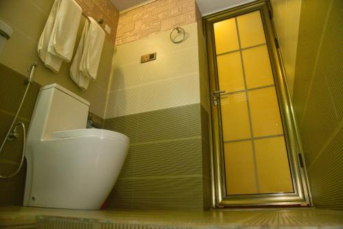 a bathroom with a toilet and a shower at Hotel Blue Sky in Kurunegala