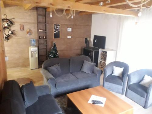 a living room with a couch and two chairs at Stara Planina Stankovic in Crni Vrh