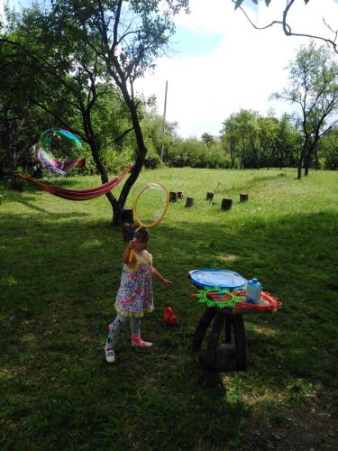 a little girl flying a kite in a park at Breb s Cosy Barn in Breb