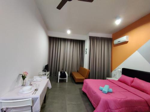 a bedroom with a pink bed and a sink at Ava Empire Damansara FRESH Room Everything Young in Petaling Jaya